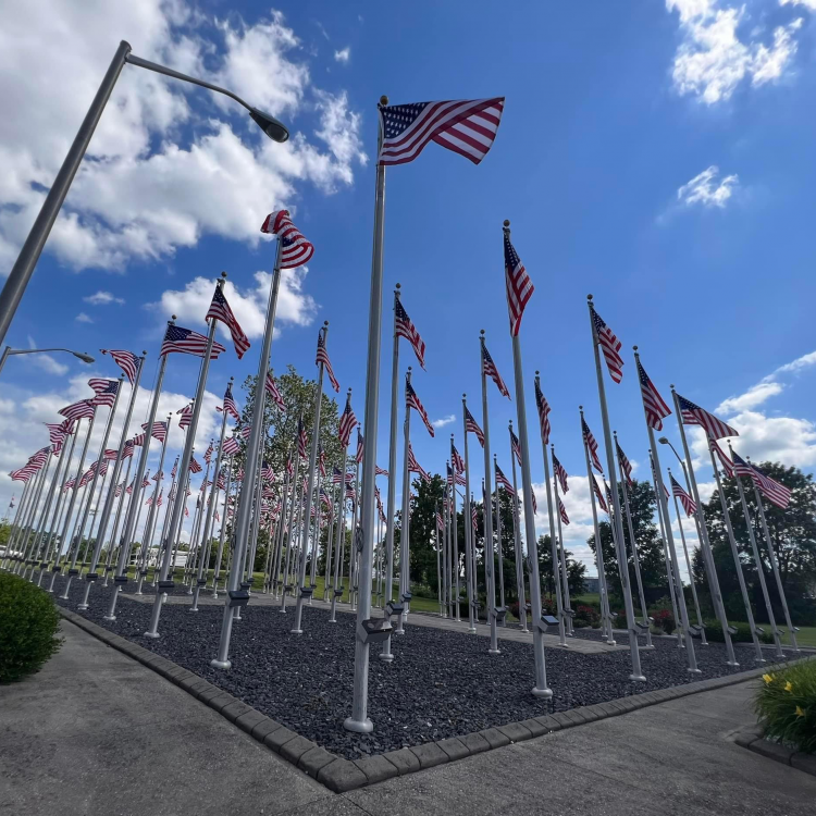  Flags flying in the wind at the local healing field honoring veterans